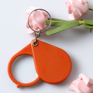 Opvouwbare sleutelhanger met vergrootglas